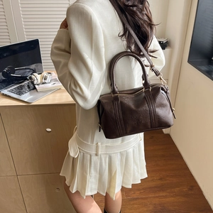 Dark coffee underarm bag with cylindrical design and adjustable strap for women