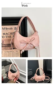 Detailed close-up of pink patent leather half-moon bag with bow and silver metal beads