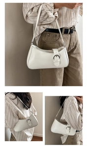 Detail view showing silver buckle and leather texture of off-white baguette shoulder bag