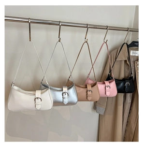 Five colors of minimalist hobo shoulder bags hanging on a metal rod showing various hues
