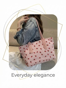 Pink strawberry tote bag with striped texture shown on shoulder for daily commute