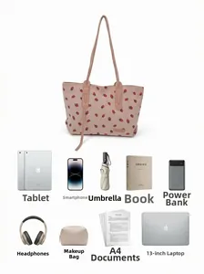 Detailed internal capacity view of pink strawberry tote showing laptop and daily essentials