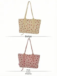 Detail view of strawberry corduroy tote bag in creamy yellow and pink color options