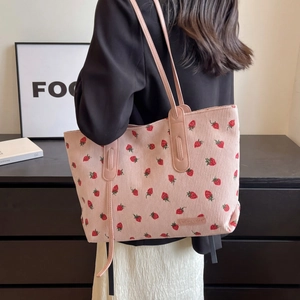 Pink corduroy tote bag with embroidered strawberry patterns and long shoulder straps