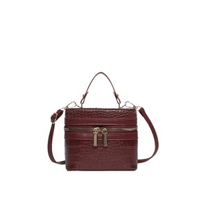 Deep burgundy crocodile-embossed box bag with top handle and gold zipper hardware