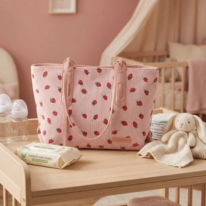 Detail of pink corduroy tote bag with strawberry prints and leather Wednesday label