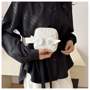 Detail view of a cream star pattern makeup bag featuring white plush angel wings