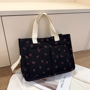 Minimalist black corduroy tote bag with red strawberry pattern and double front pockets