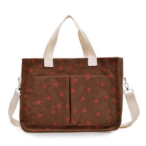 Brown corduroy tote bag with strawberry print and double front pockets with white straps