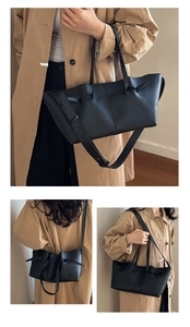 Close-up of black leather tote bag featuring elegant side knot details and smooth texture