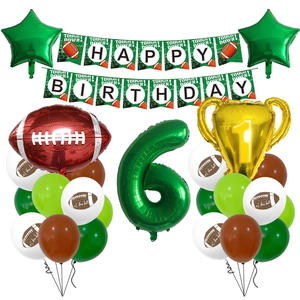 Detail of football party kit with trophy balloon, number 6, and themed banners for boys