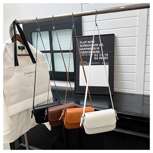 Vue détaillée de sacs carrés à rabat minimalistes en quatre couleurs sur support