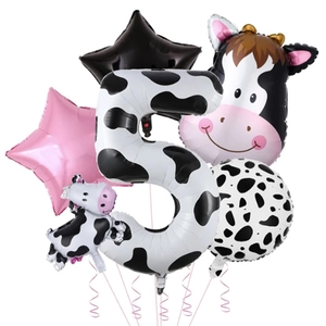 Detail set of cow print birthday party balloons featuring a large number 5 and cow shapes
