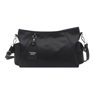 Minimalist black nylon shoulder bag with adjustable strap and side pockets on white background
