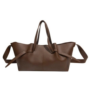 Minimalist dark brown leather tote bag with side knot details and adjustable shoulder strap