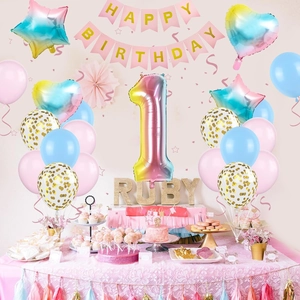 Detail of baby girl first birthday party set with gradient balloons and pink banner