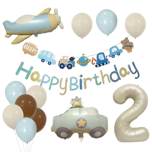 Flat lay of 2nd birthday party set with airplane, race car, and beige number 2 balloons