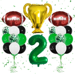 Detail of football party kit with champion trophy balloon and green number 2 foil balloon