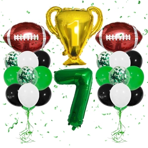 Detail of football party kit with trophy balloon and giant green number seven balloon