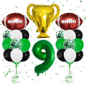Detail of football party kit with champion trophy, number 9, and green latex balloons