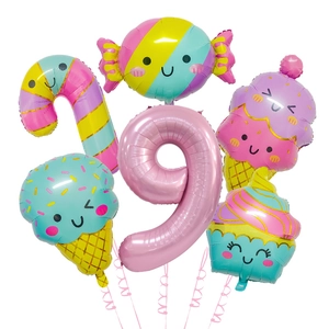 Macro detail of number 9 foil balloon and ice cream candy themed party decoration set