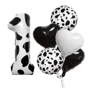Close-up of 6-piece cow print number 1 balloon set with black and white heart balloons