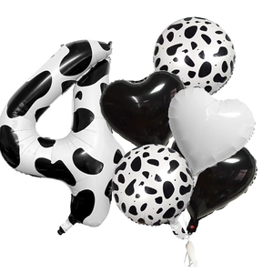 Detail view of 6-piece cow print party balloons set including number 4 and heart shapes