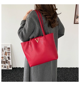 Detailed back view of a large red lychee leather tote bag with gold V logo and slim straps