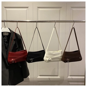 Row of faux leather baguette bags in four colors with decorative belt buckles and straps