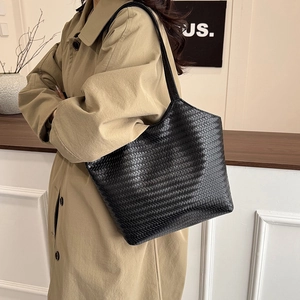 Chic black woven tote bag for women shown as a stylish large capacity shoulder bag