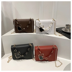 Detail of four colorful mini square bags with decorative resin and metal chunky chains