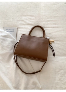 Flat lay of vintage brown faux suede square tote bag with baseball bat charm detail