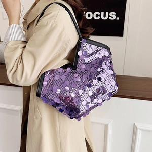Fashionable purple sequin hobo bag with black leather shoulder strap shown on model