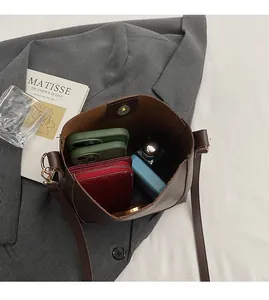 Detail view of large brown bucket bag interior showing capacity and magnetic closure