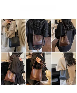 Detail shots of minimalist leather bucket bag in black and brown with shoulder strap