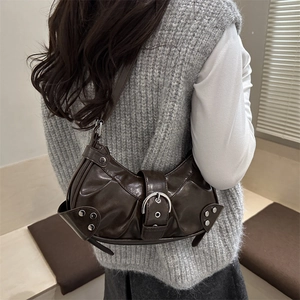 Retro dark brown pleated shoulder bag with metal buckle and studs on gray knit dress