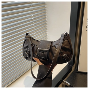 Detail of vintage dark brown shoulder bag with leather strap buckle and pleats
