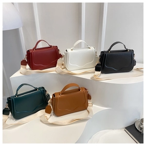 Detailed view of assorted colors saddle bags with wavy flap and wide fabric shoulder straps