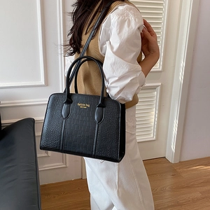 Fashionable black crocodile embossed leather handbag with top handles and shoulder strap