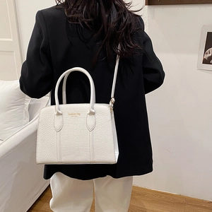 Minimalist white crocodile texture tote bag with Fashion Bag New York print shown on a model