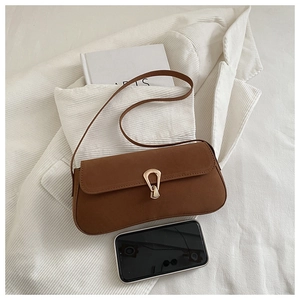 Brown faux suede shoulder bag featuring a gold horseshoe buckle and long rectangular design