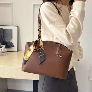 Brown large-capacity faux leather tote bag with elegant decorative silk scarf