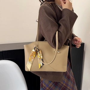Chic beige matte leather tote bag with printed silk scarf handle for winter fashion