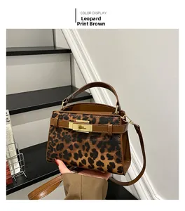 Detail view of Leopard Brown print handbag with Kelly-style metal lock and top handle strap