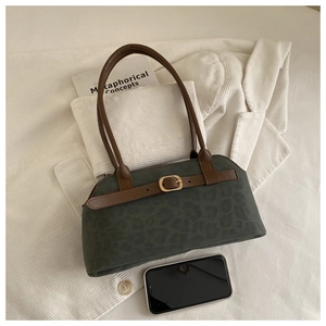 Detail of vintage dark green leopard print tote bag with gold buckle and brown handles