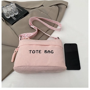 Pink corduroy tote bag detail with TOTE BAG embroidery and wave pattern wide strap
