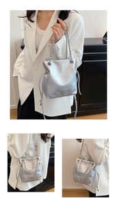 Detail of silver bucket bag with chain strap and metallic drawstring closure