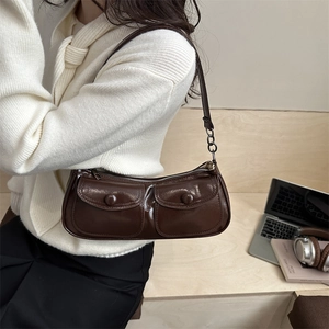 Vintage dark brown faux leather underarm bag with double front buckle pockets and sleek finish