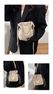 Off-white bucket bag shown in multiple styling views with metal chain and drawstring