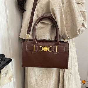 Brown vintage leather handbag with gold heart hardware and detachable shoulder strap
